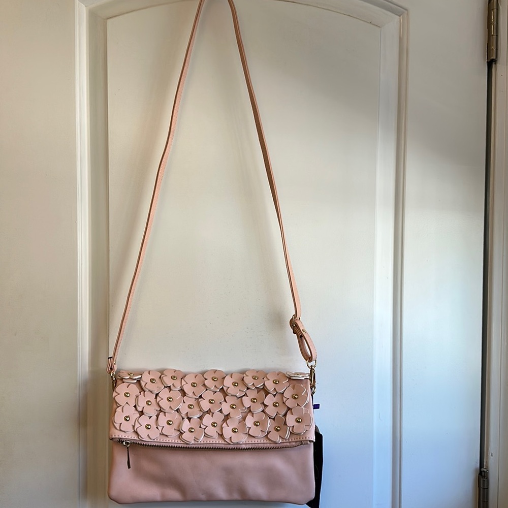 Cross body bag in powder pink color with tag. never used
